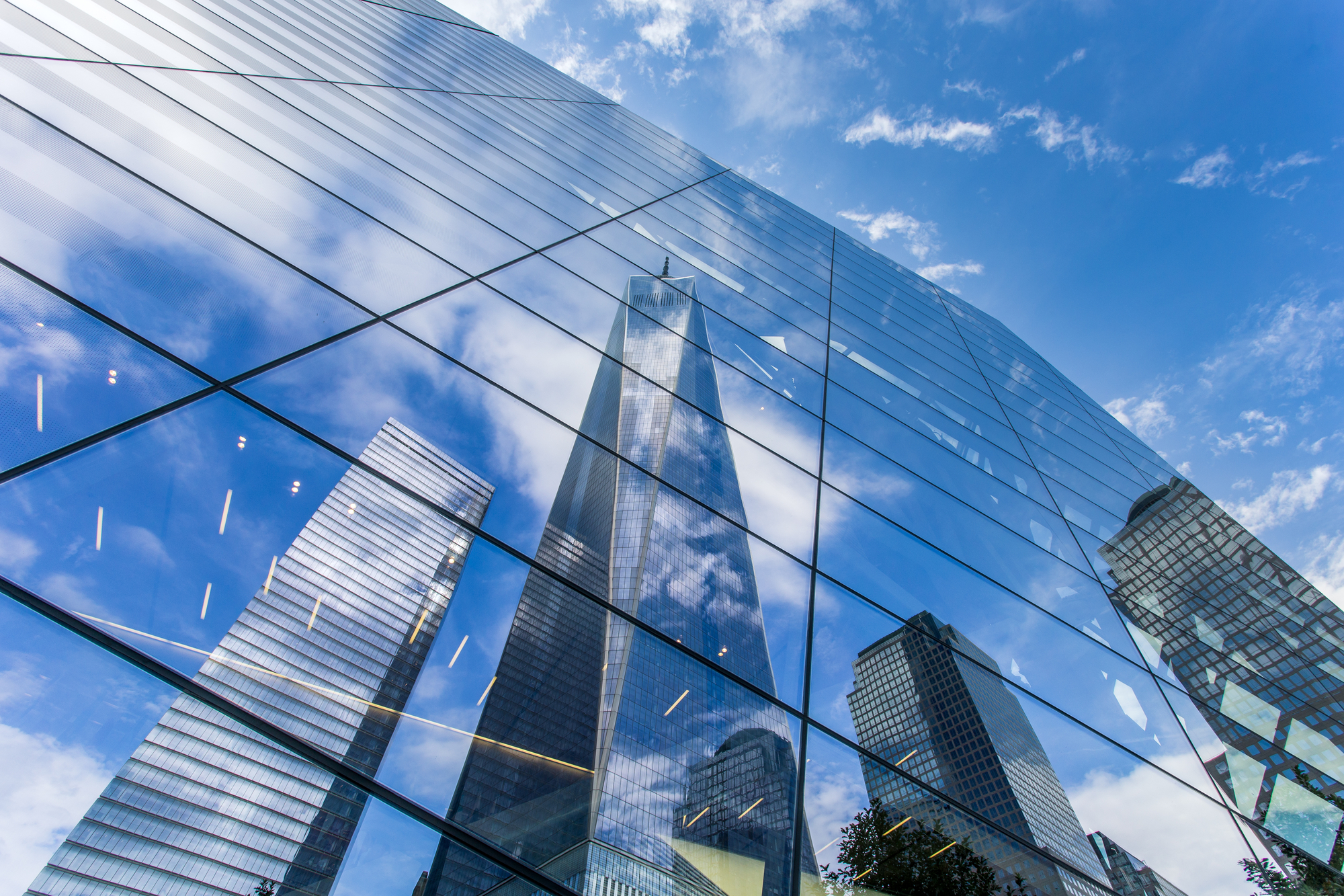 The Freedom Tower in New York City reflecting in the mirrored facade of the 9/11 memorial museum; Shutterstock ID 447930982; purchase_order: Limited 2/3/22; job: ; client: ; other: